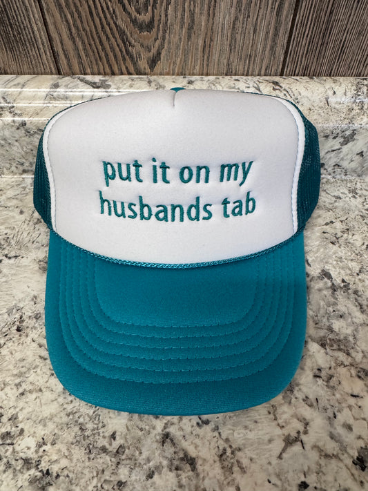 Put It On My Husband's Tab Embroidered Trucker Hat